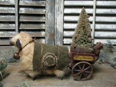 an old fashioned toy horse pulling a wagon with a christmas tree on it's back