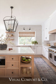 a kitchen with white cabinets and an island