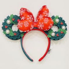 a red and green mickey mouse ears with snowflakes on it