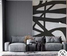 a living room with black and white wallpaper, grey couches and rugs