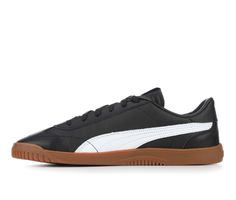 a black and white puma sneaker with gum soles on the bottom side