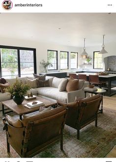 a living room filled with furniture and lots of windows