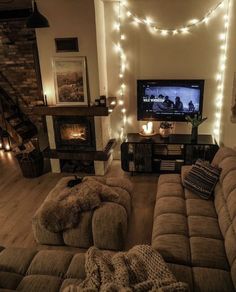 a living room filled with furniture and a flat screen tv sitting on top of a wooden floor