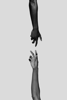 two hands reaching for each other in the air with one hand extended up to another