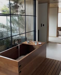 a large wooden bathtub sitting next to a window