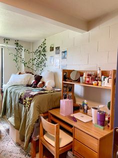 a bedroom with a bed, desk and shelves on the wall next to an open door