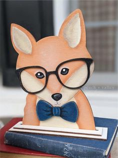 a paper sculpture of a dog wearing glasses and a bow tie on top of a book