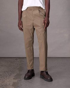 Classic menswear made modern. Our chino is pleated with a slightly tapered silhouette. It's crafted in a striped stretch cotton-blend, perfect for year-round wear. Desert Stripe 31 Relaxed Fit Vertical Stripe Workwear Pants, Relaxed Fit Vertical Striped Pants For Workwear, Vertical Stripes Tapered Leg Workwear Bottoms, Tapered Leg Bottoms With Vertical Stripes For Workwear, Tailored Tapered Leg Pants With Vertical Stripes, Tailored Tapered Leg Bottoms With Vertical Stripes, Tailored Pants With Vertical Stripes And Tapered Leg, Men Apparel, Classic Menswear