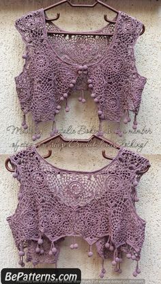 two purple crocheted bras hanging on a wall