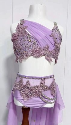 a mannequin wearing a purple dress with sequins on the top and bottom