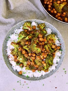 a bowl filled with broccoli and chickpeas on top of white rice