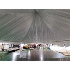 the inside of a large tent with tables and chairs