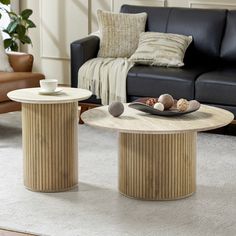 two coffee tables sitting on top of a white rug