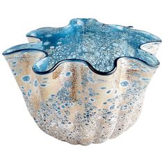 a blue and white glass bowl sitting on top of a table