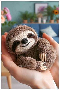 a hand holding a small stuffed slotty animal