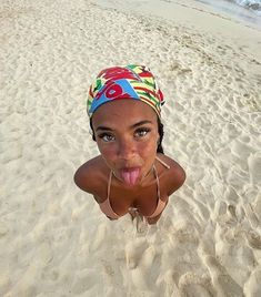 a woman sticking her tongue out on the beach