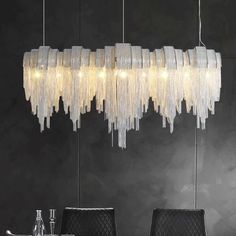 a chandelier hanging over a dining room table