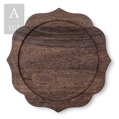 a wooden plate with an ornate design on the front and side, set against a white background