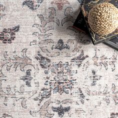 a rug with an intricate design on it and two books laying next to each other