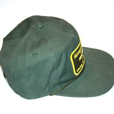 The ranger style hat features a trendy flat bring style with tonal cord detail for a modern touch. Features the Murray's Fly Shop name with a popper embroidered on the front. One size fits most with the leather adjustable metal clasp on the back. FEATURES FABRIC : 100% BRUSHED COTTON TWILL SHAPE : STRUCTURED MEDIUM PROFILE CLOSURE : LEATHER METAL CLASP SIZE : OSFM VISOR : FLAT DETAILS : SEAMLESS FRONT PANEL, INTERNAL MESH STAY, BRAIDED CORD AT VISOR Military Hat With Flat Bill For Outdoor Activities, Military Flat Bill Hat For Outdoor Activities, Military Snapback Hat With Flat Bill For Outdoor, Military Style Adjustable 5-panel Trucker Hat, Adjustable Military Style 5-panel Trucker Hat, Adjustable Snapback Hat With Logo Patch And Flat Brim, Vintage Hats With Short Brim For Outdoor Activities, Military Style Flat Brim Trucker Hat For Outdoor, Adjustable Military Style 5-panel Hat