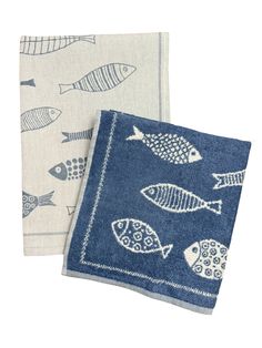 two towels with fish on them sitting next to each other