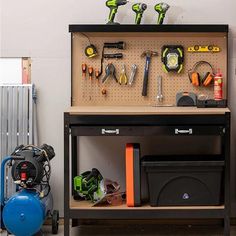 a workbench with tools on it and other items in the back ground next to an air compressor