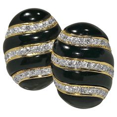 This lovely pair of 18k yellow gold, onyx and diamond earrings are crafted to the very highest level of quality. Set with 62 round brilliant cut diamonds having a total approximate weight of 2.00ct. of overall F/G color and VS1 clarity. The undulating 18k white gold and diamond strips are flanked by custom cut black onyx panels.The earrings measure 1 1/8 inches long by 7/8 inches wide by just under 3/8 inches high. Stamped 18k and 750. The backs are fold-down Omega clip style with posts, making Luxury Oval Diamond Earrings For Evening, Oval Earrings With Diamond Accents For Evening, Onyx Earrings, Antique Diamond, Vintage Designer, Round Brilliant Cut Diamond, Diamond Gemstone, Round Brilliant Cut, Brilliant Cut Diamond