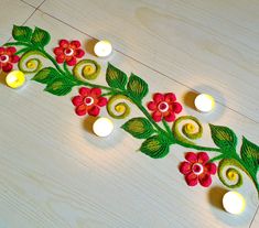 a decorated table with candles and flowers on the side, next to it is a candle holder