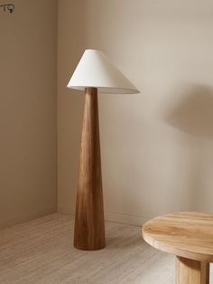 a wooden table sitting next to a white lamp