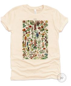 * A shirt inspired by the beautiful hand-drawn wildflowers by Adolphe Millot (1857-1921) included in 1909 Le Larousse pour tous : nouveau dictionnaire encyclopédique * Perfect gift for nature enthusiast, outdoorsman and mushroom whisperer in your life. Printed on super soft premium cotton shirts - you will love wearing it! * Printed with Direct to Garment textile printer, creating soft to touch (i.e no layer on top of the shirt) full-color print that does not fade. Not an iron-on or heat transfe Jane Austen Shirts, Outdoorsy Shirt, Adolphe Millot, Wildflower Shirt, Nature Enthusiast, Botanical Shirt, Custom Aprons, Personalized Aprons, Gardening Shirts