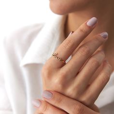 Our new lovely minimalist 14K solid gold love script ring. Simple and elegant. 14K solid gold is perfect for everyday use since it will not tarnish, and you don't have to worry about contact with conditioners or water. A perfect ring to stack as well.★ Ring Features• Gold Kt: 14Kt Solid Gold (All pieces are stamped for authenticity)• Available Gold Colors: Yellow Gold• Love Script Dimensions: 15.0 mm by 6.0 mm / 0.59 Inch by 0.24 Inch• Band Width 1.20 mm Elegant Everyday Rings With Custom Name, Elegant Custom Name Rings For Everyday, Elegant Custom Name Ring For Everyday, Elegant Custom Name Ring, Love Script, Gold Colors, Ring Simple, Perfect Ring, Solid Gold