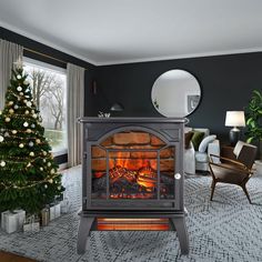 a living room with a christmas tree and a fire place in the middle of it