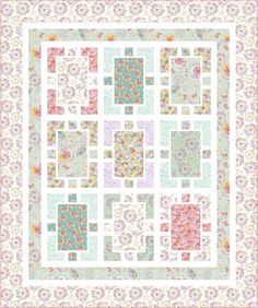 a square quilt with many squares and flowers in pastel colors on the bottom half