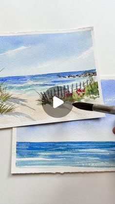 someone is painting the beach with watercolors on paper and then using a brush