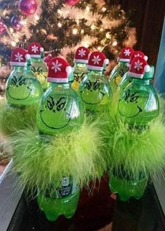 grin - face water bottles are lined up in front of a christmas tree