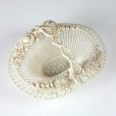 a decorative white basket on a white background