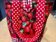 "Oh - such a lifelike strawberries print! You'll be the envy of all your friends with this beautiful practical bag. A full quilted lining makes this tote bag very sturdy! This is a tote bag that I made of a strawberries print cotton fabric with coordinating ribbon and fabric strips at the bottom of the bag. The measurements are 10\" tall by 12\" and the straps are each 21\" which mean a 10.5\" drop made of a coordinating red and white dots fabric. The inside of the bag is made with a white quilt Casual Rectangular Bag With Strawberry Print, Casual Strawberry Print Rectangular Bag, Casual Rectangular Strawberry Print Bags, Trendy Rectangular Bag With Strawberry Print, Red Bag With Strawberry Print As Gift, Red Quilted Bag For Daily Use, Strawberry Print Tote Bag For Daily Use, Rectangular Bag With Strawberry Print As Gift, Rectangular Bags With Strawberry Print For Gifts