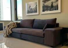 a living room filled with furniture and pictures on the wall next to a large window