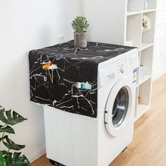 a white washer sitting next to a dryer on top of a wooden floor