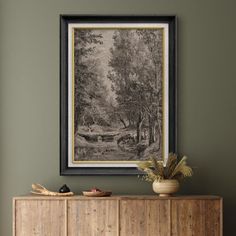 a painting hanging on the wall above a wooden cabinet