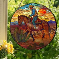 a stained glass cowboy riding a horse in the desert