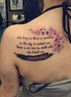 a woman with a tattoo on her back that says, as long as there is someone in the sky to protect me there is no one on earth who can break me