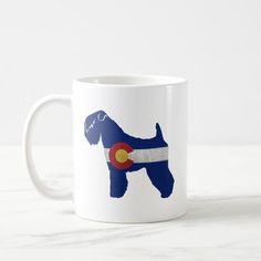 a coffee mug with the flag of colorado and a dog's silhouette on it