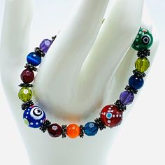 Multi-colored Boho-Hippie Lampwork Glass Bead Bracelet measures 2 3/4 inches across and stretches nice combination of different colors of glass beads Colorful Czech Glass Beads Stretch Bracelet, Adjustable Czech Glass Beads Bracelet, Multicolor Czech Glass Hand-strung Beaded Bracelets, Bohemian Glass Stretch Bracelet With Colorful Beads, Adjustable Czech Glass Round Beads Stretch Bracelet, Handmade Adjustable Czech Glass Stretch Bracelet, Handmade Casual Glass Bracelets, Casual Handmade Glass Bracelets, Casual Handmade Glass Bracelet