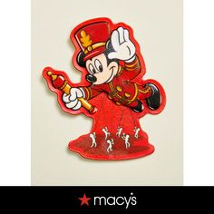 a red mickey mouse magnet with the words macy's on it and an image of a man in a top hat