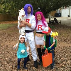 three people dressed up in costumes posing for a photo with one child and the other adult