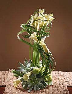 the flowers are arranged on top of the table