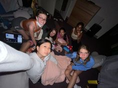 a group of young women sitting on the floor