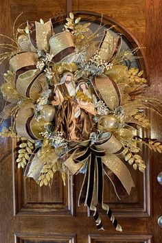 a wreath on the front door of a house with an image of mary in it