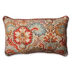 an orange, blue and red pillow on a white background with a decorative design in the middle